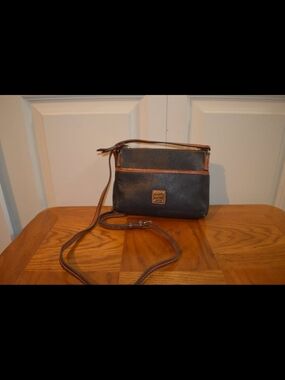 Dooney And Bourke Classic Black Pebbled Leather Crossbody Bag with Brown Trim